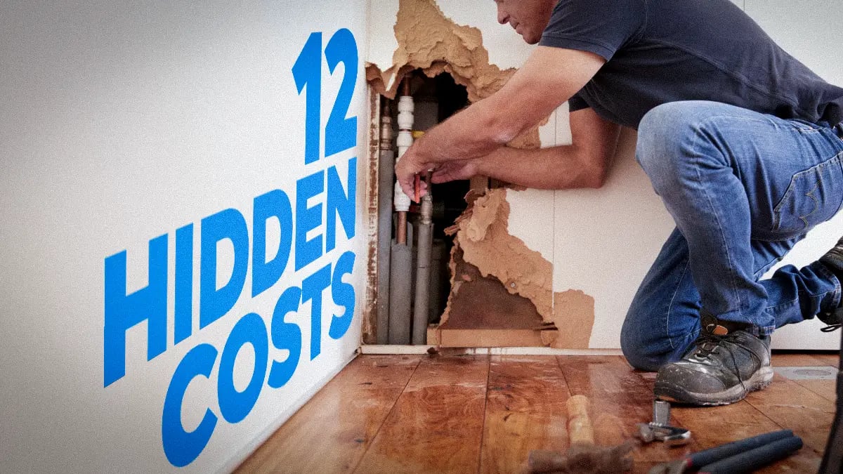 Restoration contractor repairing plumbing tubes on a wall and finding 12 hidden costs for his estimate 