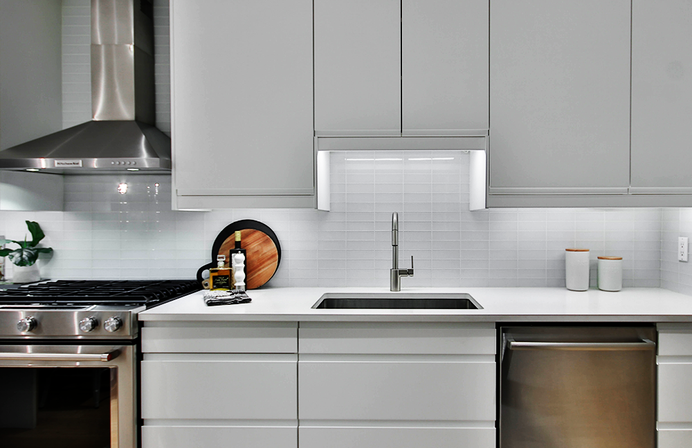 modern minimalist white kitchen with new lighting installation LED