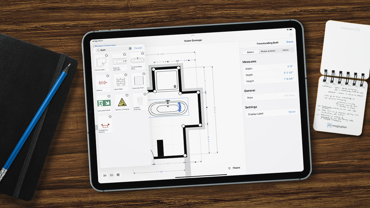 A tablet in wood table showing a magicplan app floor plan