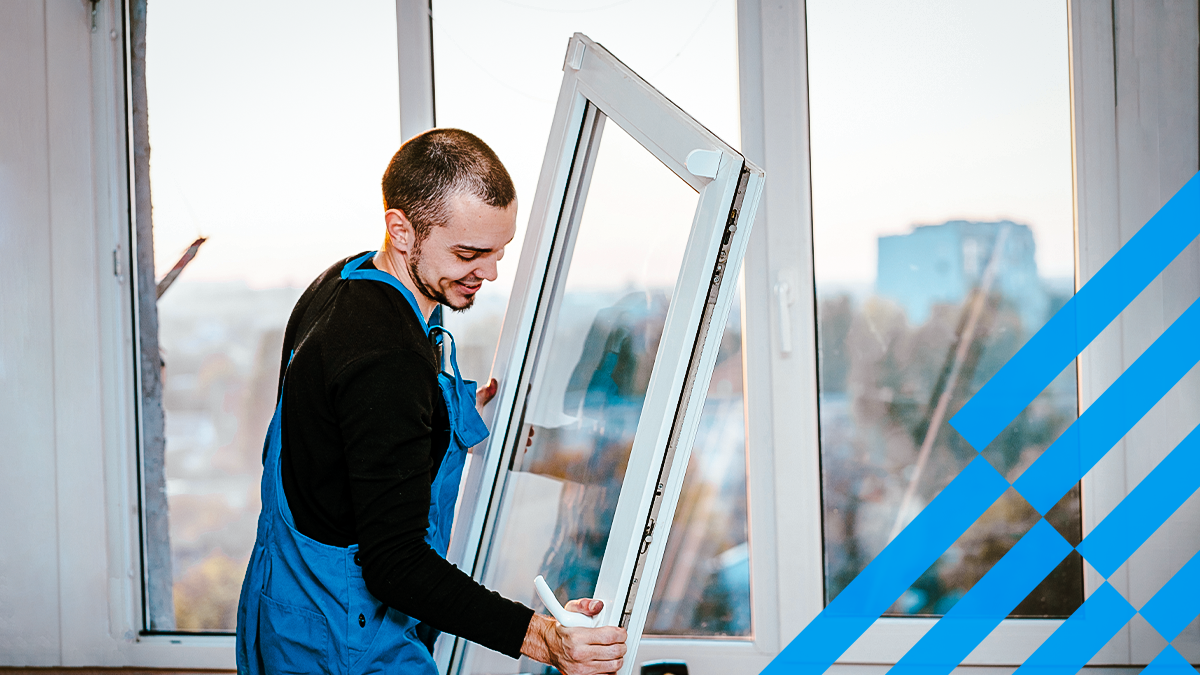 A professional window installer attaches a window in a unit.