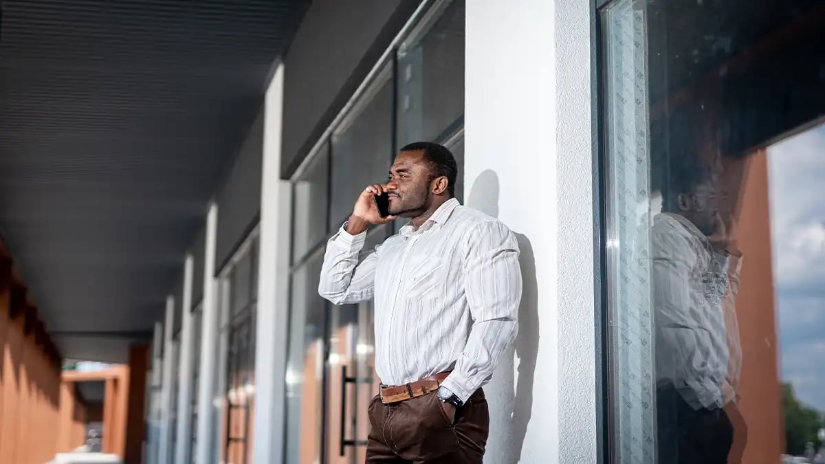 a man on a phone calling a co-contractor about a restoration job project