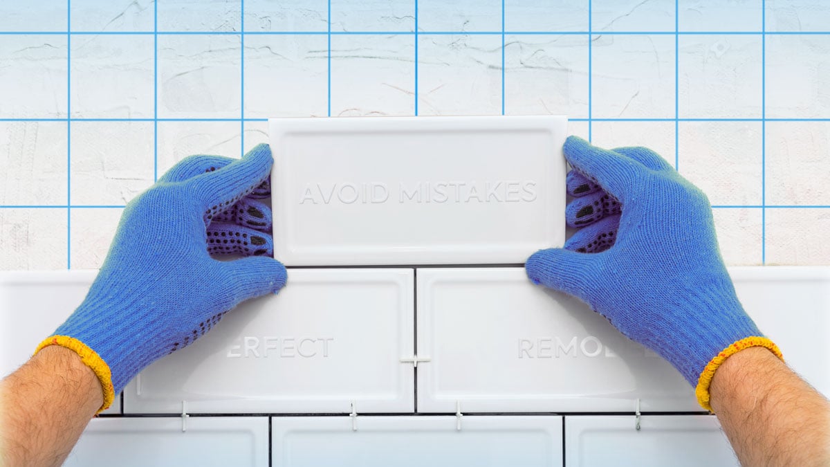 contracto with blue gloves installing kitchen white tiles with avoid mistakes text 