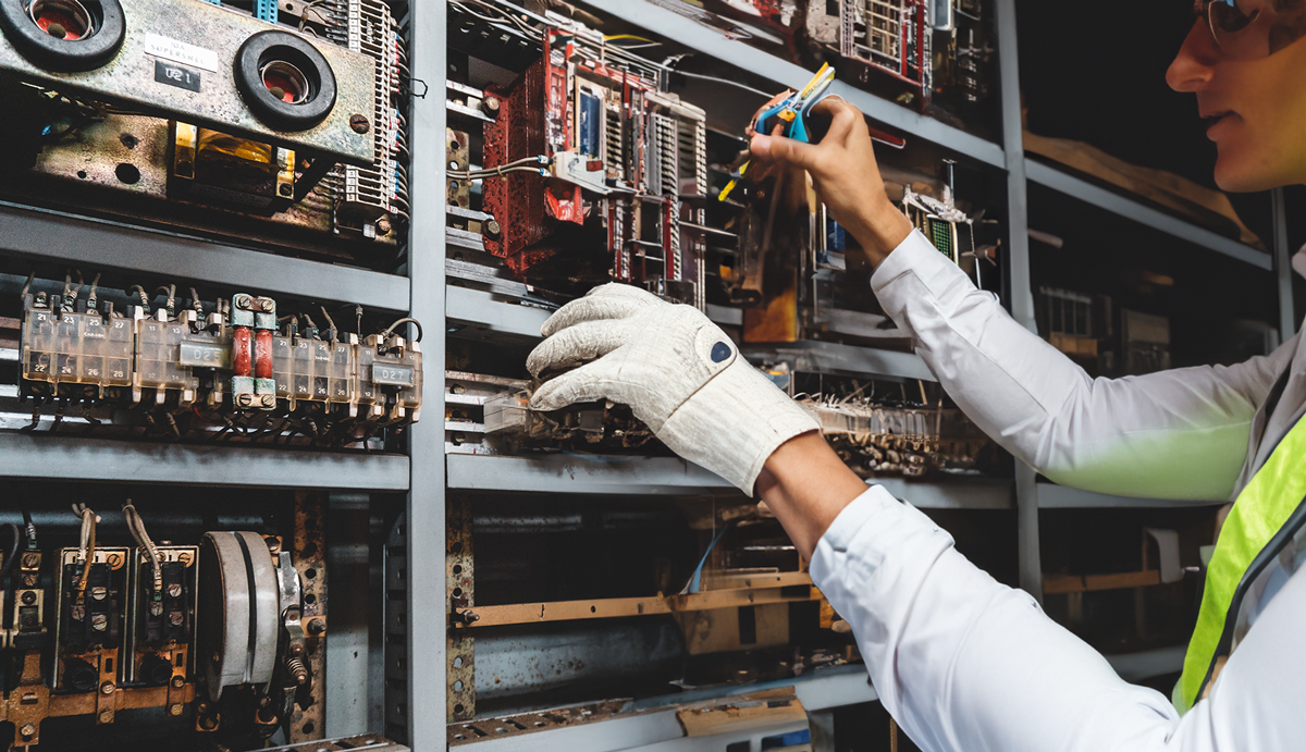 An expert working on an electrical, plumbing or HVAC system in a commercial building