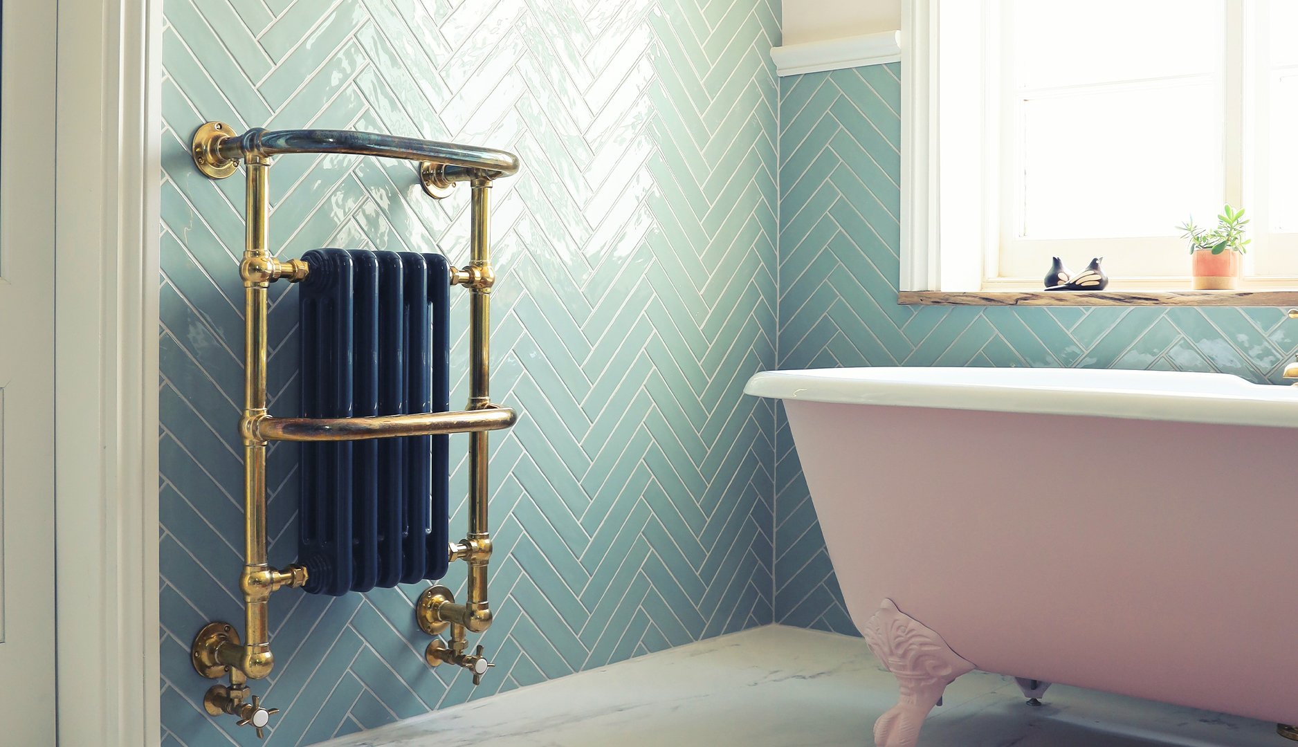 nature inspired bathroom with a pink tub and green tiles on the wall