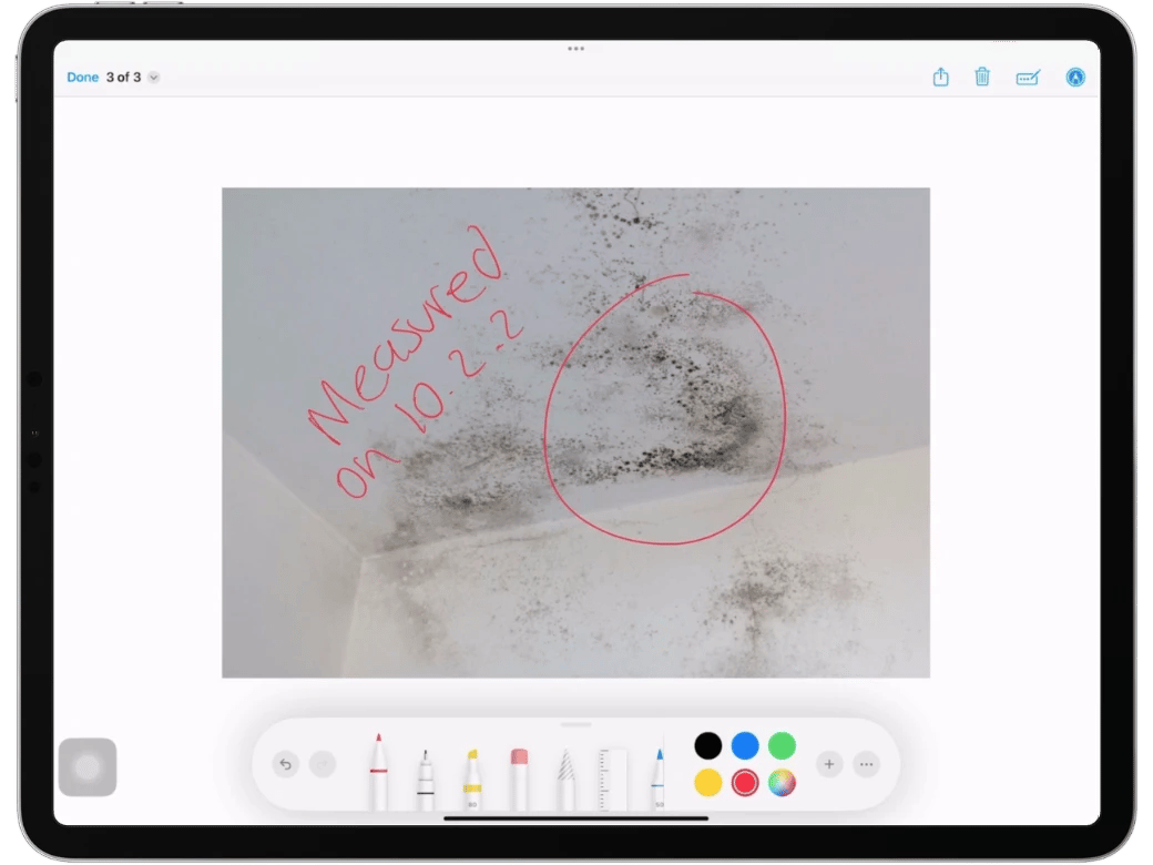 Photo of white wall with mold at water damage restoration job with a markup annotation photo with the date it was measured and a circle using the magicplan app on an iPad Pro.